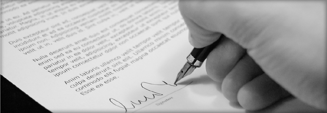 Close up of a male hand signing a document
